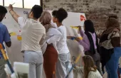 Group of young people painting a mural