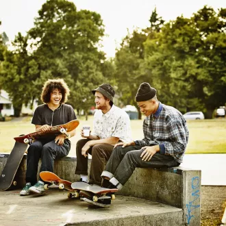Group of young people at a skate park having a laugh