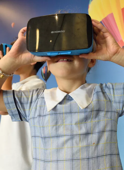 A photo of a child using a VR headset