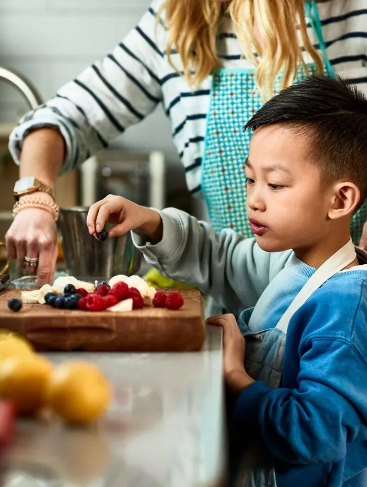 Food-young child and parent preparing food in kitchen